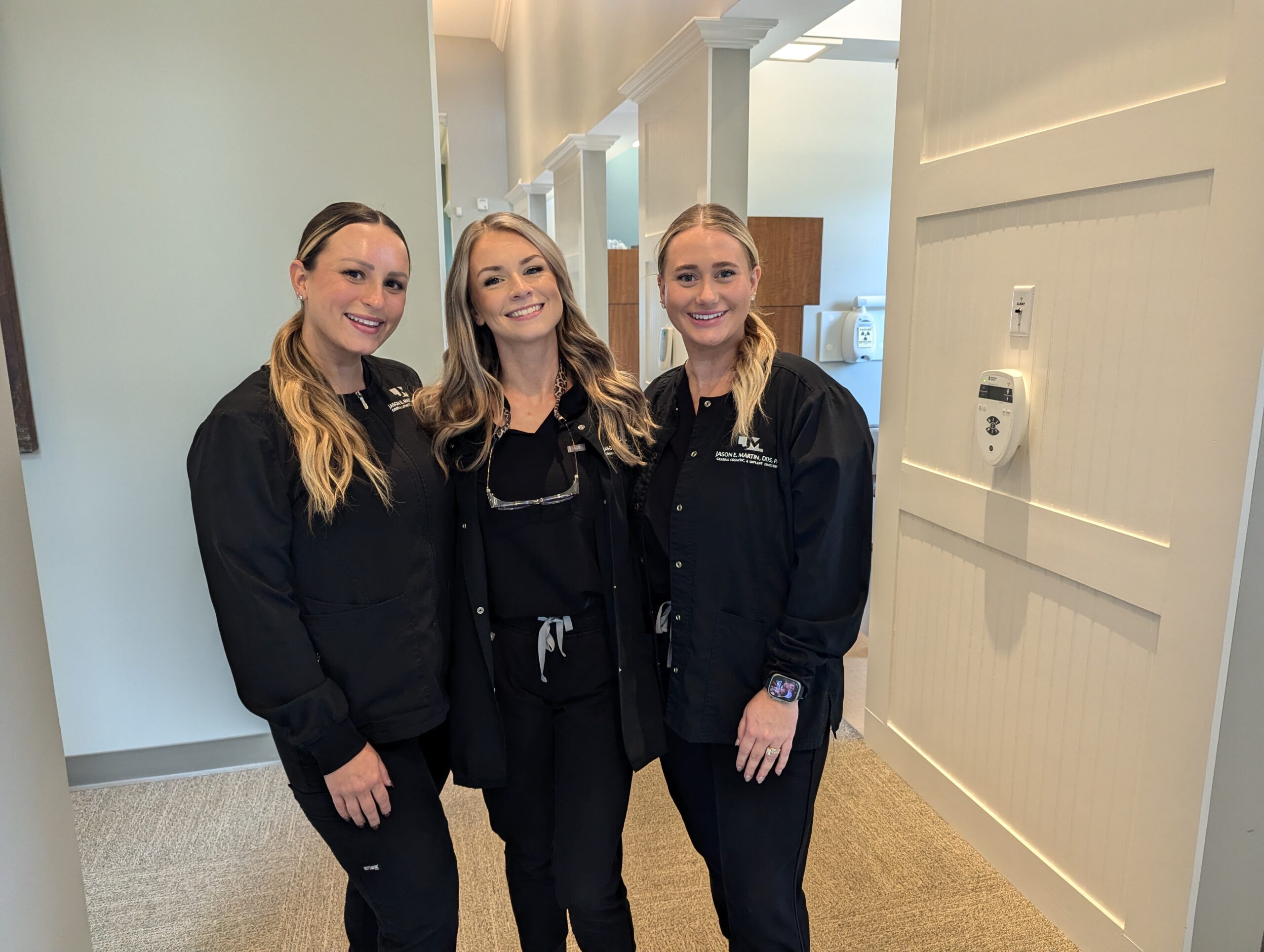 3 members of the Martin and Brune Team standing in the hallway.